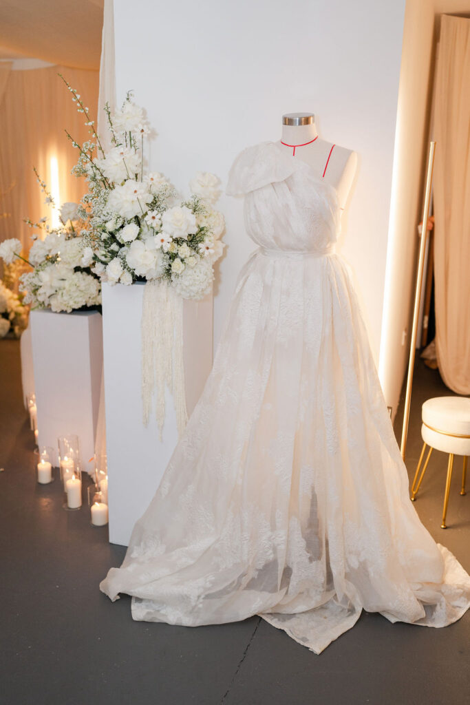 Mara Marie Bridal wedding dress next to a flower arrangement on a pedestal